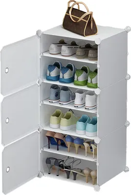 A white modular shoe cabinet filled with various shoes and a handbag on top.