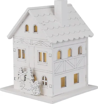 A white wooden house decoration with illuminated windows.