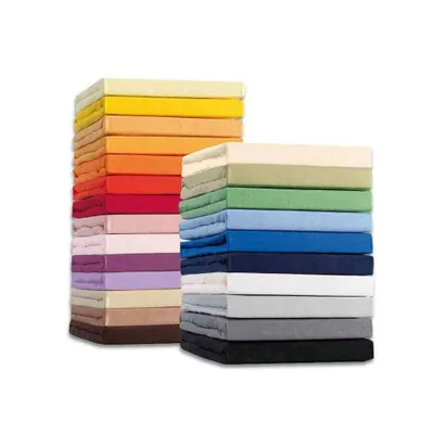 Two stacks of folded fitted sheets in various colors.