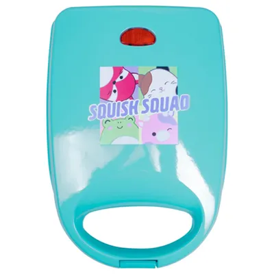 A teal colored waffle maker with a graphic of cartoon characters and the text "SQUISH SQUAD" on the lid.