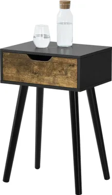 A black side table with a wooden drawer front and three black legs, shown against a white background. A glass of water and a bottle of water are on top of the table.