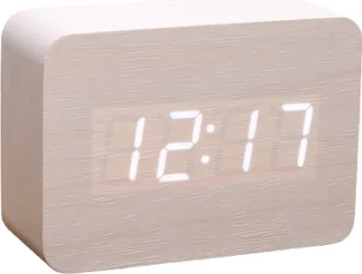 A digital clock with a wood-like finish displaying the time.