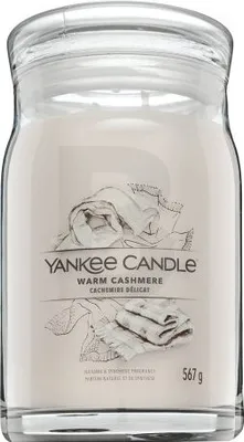 A Yankee Candle jar with a label showing a drawing of folded fabric.