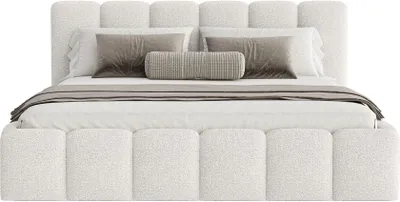 A white upholstered bed with pillows and a throw blanket.