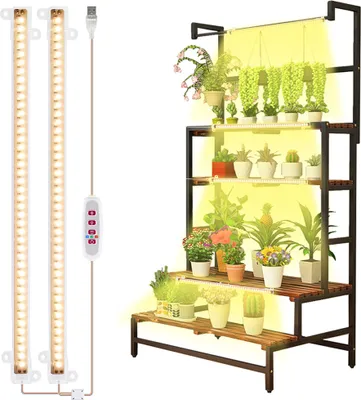 A multi-tiered plant stand with various potted plants, illuminated by grow lights.