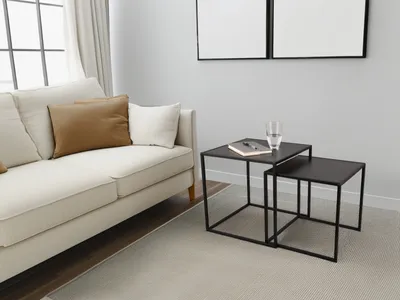 A living room scene with a couch and nesting tables.
