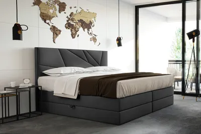 A modern bedroom with a large bed and a world map decoration on the wall.