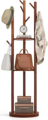 A wooden coat rack with shelves, bags, a hat, a clock, and boxes.