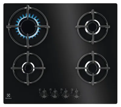 A top-down view of a black gas stovetop with four burners. One burner is lit with a blue flame.