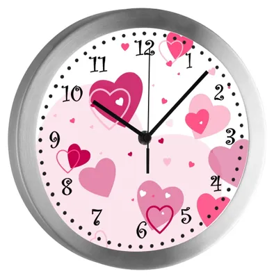 A close-up of a wall clock with a pink heart design.
