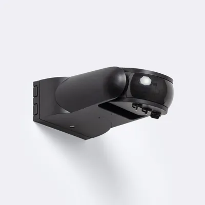 A black radar motion sensor with a twilight sensor, mounted on a white wall.