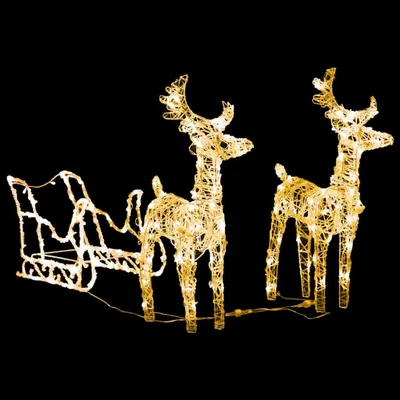 A lighted Christmas decoration of a sleigh and two reindeer on a black background.