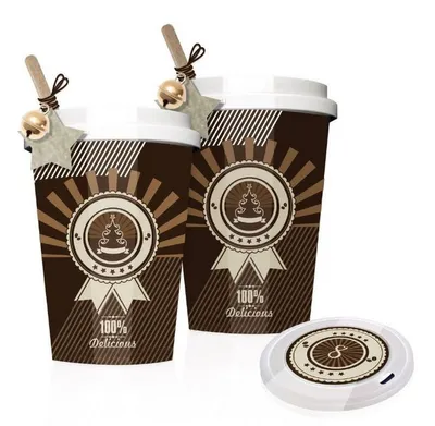 Two decorated coffee cups with festive embellishments and a matching coaster.