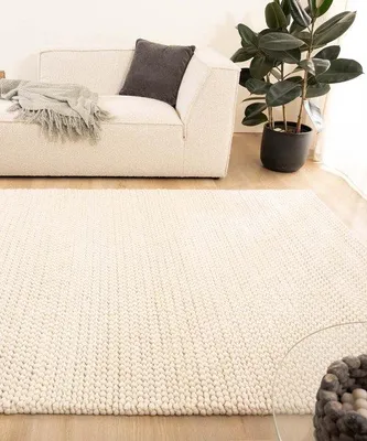 Imagen del producto de Alfombra de lana Unyqoos® Løkke – tejida a mano, color marfil, 200 x 300 cm, con textura de nudos y base de finas líneas