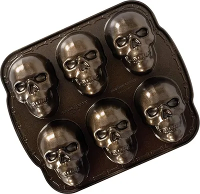 A skull-shaped cakelet pan with six cavities.