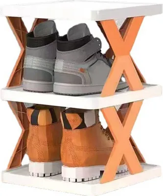 A two-tier shoe rack holding two pairs of shoes.