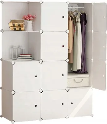 A white modular storage cube unit filled with clothes, books, and decorative items.