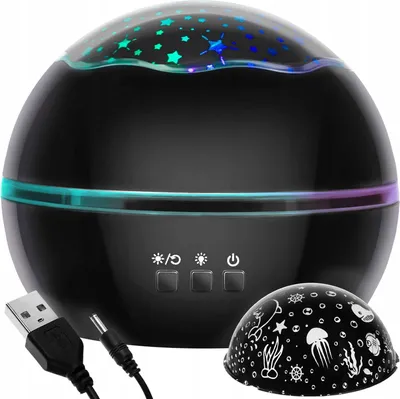 A black star projector lamp with a USB cable and a decorative dome.