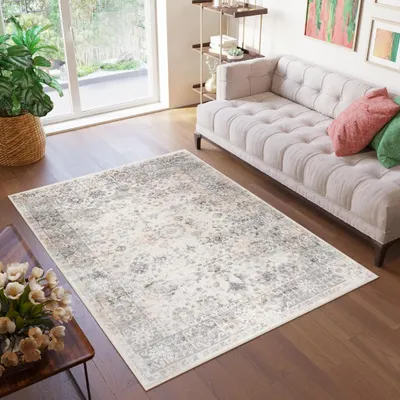A living room scene with a rug, sofa, and coffee table.