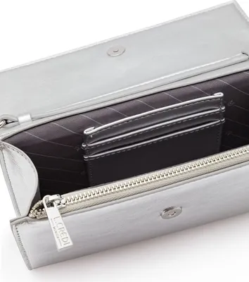 Close-up view of the interior of a silver clutch bag, showing card slots and a zipper.