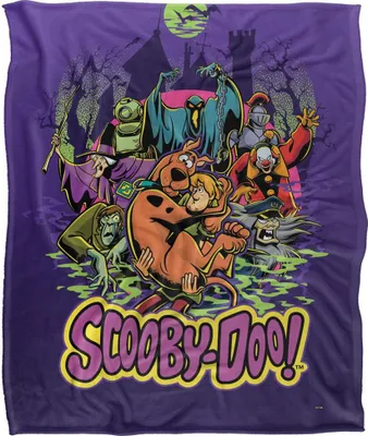 A group of Scooby-Doo characters and villains are depicted on a purple background with a spooky castle and trees.