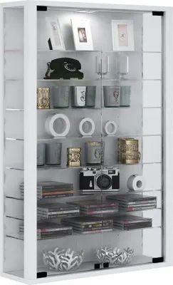 A white display cabinet filled with various decorative items and media.