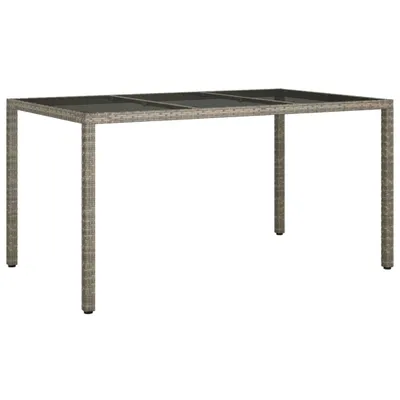 A rectangular outdoor dining table with a glass top and rattan base is shown against a white background.