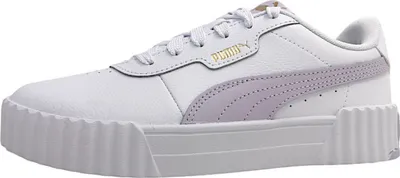 A side view of a white Puma sneaker with purple accents.