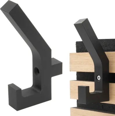 Two black coat hooks are shown against a white background. The hook on the left is shown in isolation, while the hook on the right is mounted on wooden slats with dark felt backing.