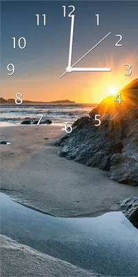 Produktbild von Wallario Design Wanduhr bedruckt, Größe 30 x 60 cm, Motiv: Sonnenuntergang hinter einem Felsen am Strand
