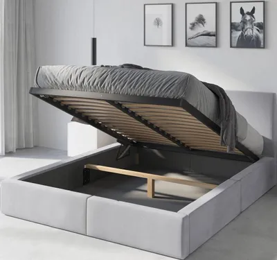 A bed with its storage compartment open, showing the slatted base and wooden supports.
