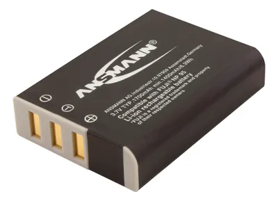 A product shot of a black battery pack with gold contacts.