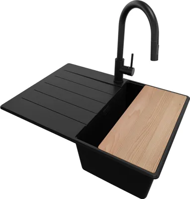 A black kitchen sink with a faucet and a wooden cutting board.