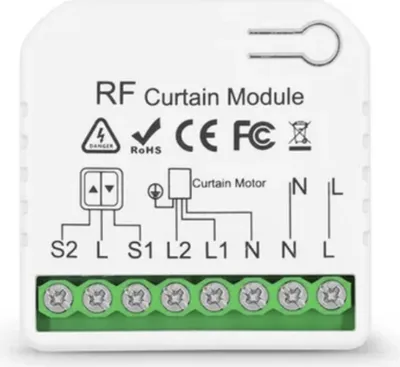 A white electronic module with green screw terminals, showing wiring diagrams and labels.