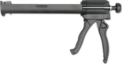 A dark gray and black caulking gun is shown against a white background.