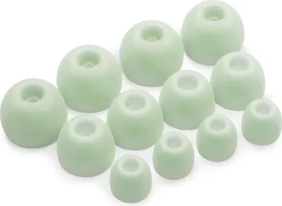 A collection of green silicone earbud tips arranged on a white background.