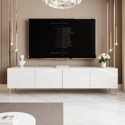A modern living room with a white TV stand and a large television screen displaying credits.