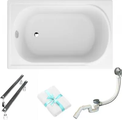 A white bathtub with accessories laid out below it.