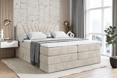 A bedroom scene featuring a large boxspring bed.