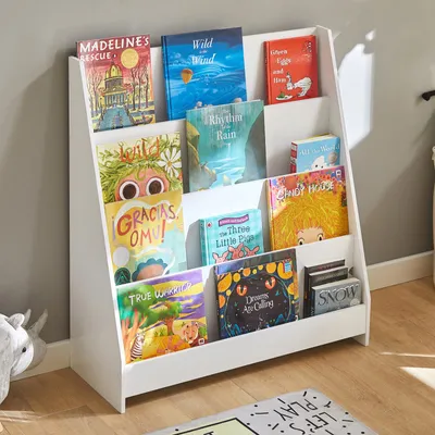 A white bookshelf filled with children's books, placed against a light gray wall.