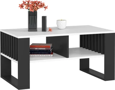 A modern coffee table with a white top and black slatted sides and legs, decorated with a vase of flowers, a small decorative object, and a candle.