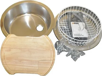 A stainless steel sink, a wooden cutting board, and a wire basket with accessories are laid out on a white background.