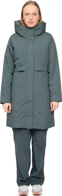 A woman wearing a green parka and matching pants stands against a white background.