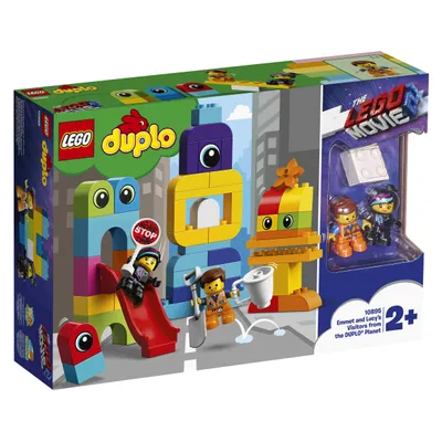 The image shows the LEGO DUPLO 'Emmet and Lucy's Visitors from the DUPLO Planet' playset packaging. The box displays the product with its components, including figures and building blocks, set against a stylized cityscape background.