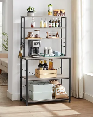 A kitchen shelf unit filled with various items like bottles, jars, a coffee maker, and storage boxes.
