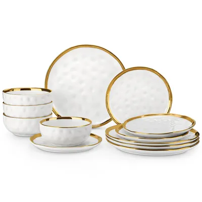 A collection of white porcelain dinnerware with gold trim, arranged on a white background.