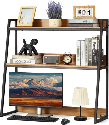 A desk shelf unit with a computer monitor, keyboard, mouse, lamp, and various decorative items.