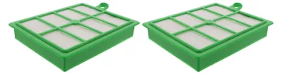 Two green and white vacuum cleaner filters placed diagonally on a white background.