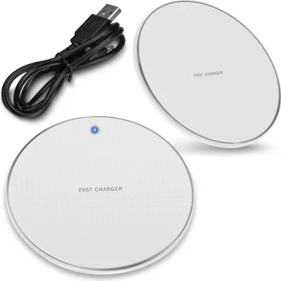Two white wireless charging pads and a USB cable are shown against a white background.