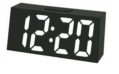 A black digital alarm clock displaying the time 12:20.